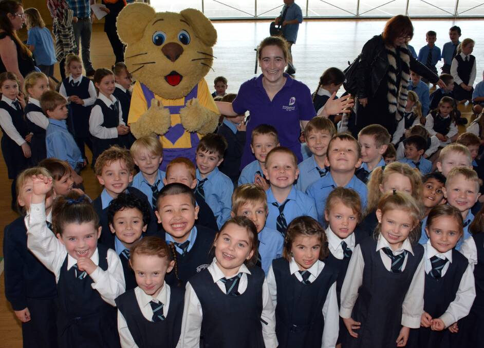 Fun with Ditto: Ditto and Nina Juhl from Bravehearts with St Josephs Primary School students.                      Photo - PETER GLEESON