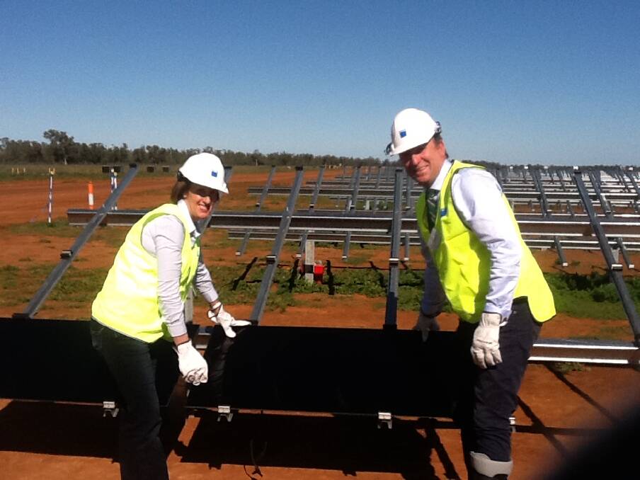 First of many: Member for Port Macquarie Leslie Williams and Minister for natural resources, Kevin Humphries with the first of 1.35 million panels being installed at Nyngan.
