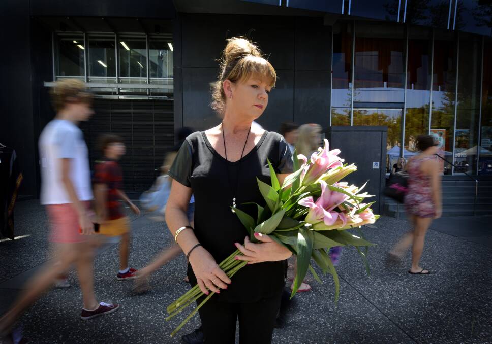 Time stops: Port Central Florist's Kelly Hart will be participating in today's #illridewithyouportmacquarie where local residents will stop and remember the Martin Plaza siege at 2.11pm. Pic: PETER GLEESON.