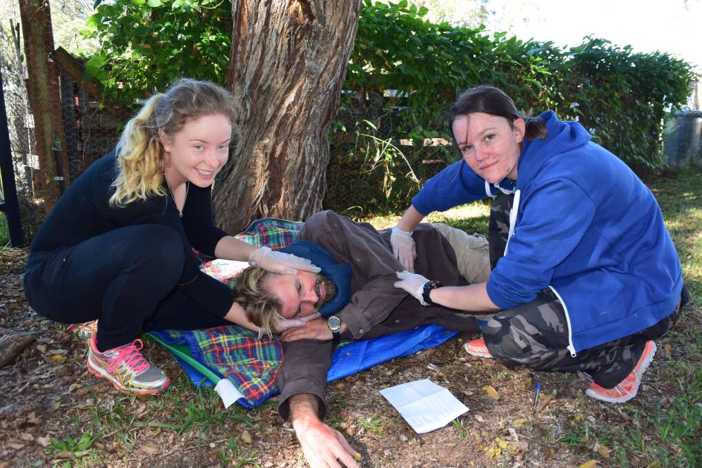 Caitlin Hosken from Young and CSU student Kymara Runchel-Fitzsummons hone their first aid skills while Ian Hamilton from Noosa