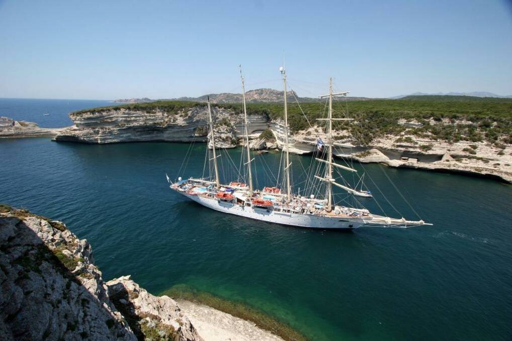 One of Star Clippers' tall ships sails into a cove in Corsica. Photo: Star Clippers