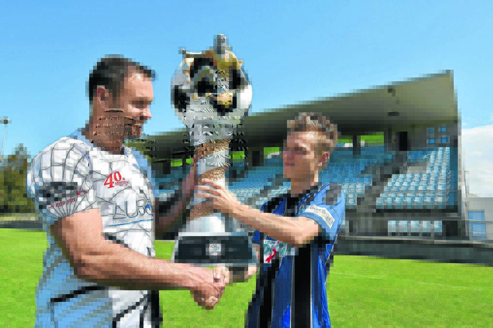 Big game awaits: Camden Haven Redbacks skipper Ryan Squires and Port Saint Michael Bishop get their hands on the premiers trophy ahead of the Football Mid North Coast Premier League grand final tomorrow at Regional Stadium.  
Pic: NIGEL McNEIL