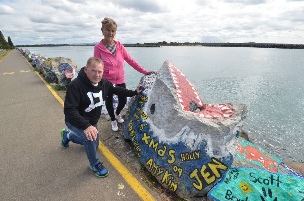 Part of the landscape: Kay and Denny Thompson admire the rock art on the breakwall.