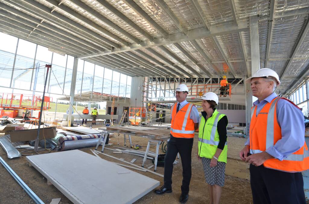On schedule: Lake Cathie Public School principal Jock Garven, Port Macquarie MP Leslie Williams and project manager Garry Fricke at the entrance to the auditorium.