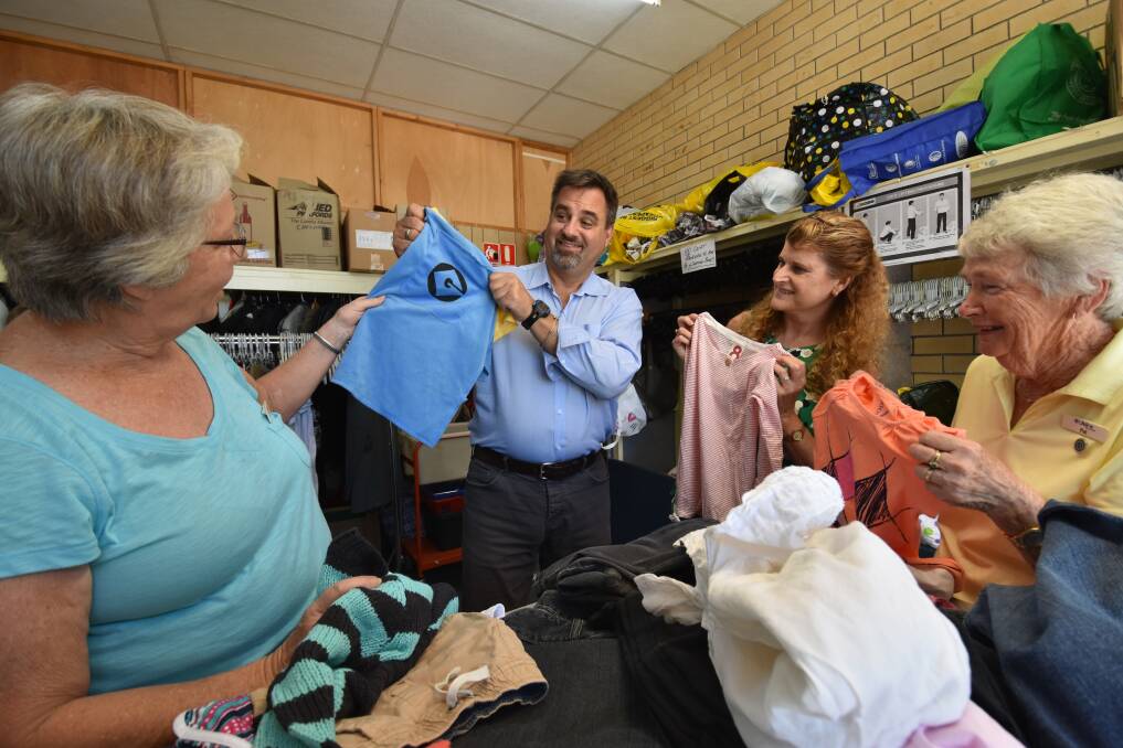 Helping hands: Lifeline chief executive officer Peter Shmigel helps volunteer Judy Kelly, Mid North Coast chief executive officer Catherine Varra and volunteer Pat Northey sort clothing at the Port Macquarie branch. Pic: NIGEL McNEIL