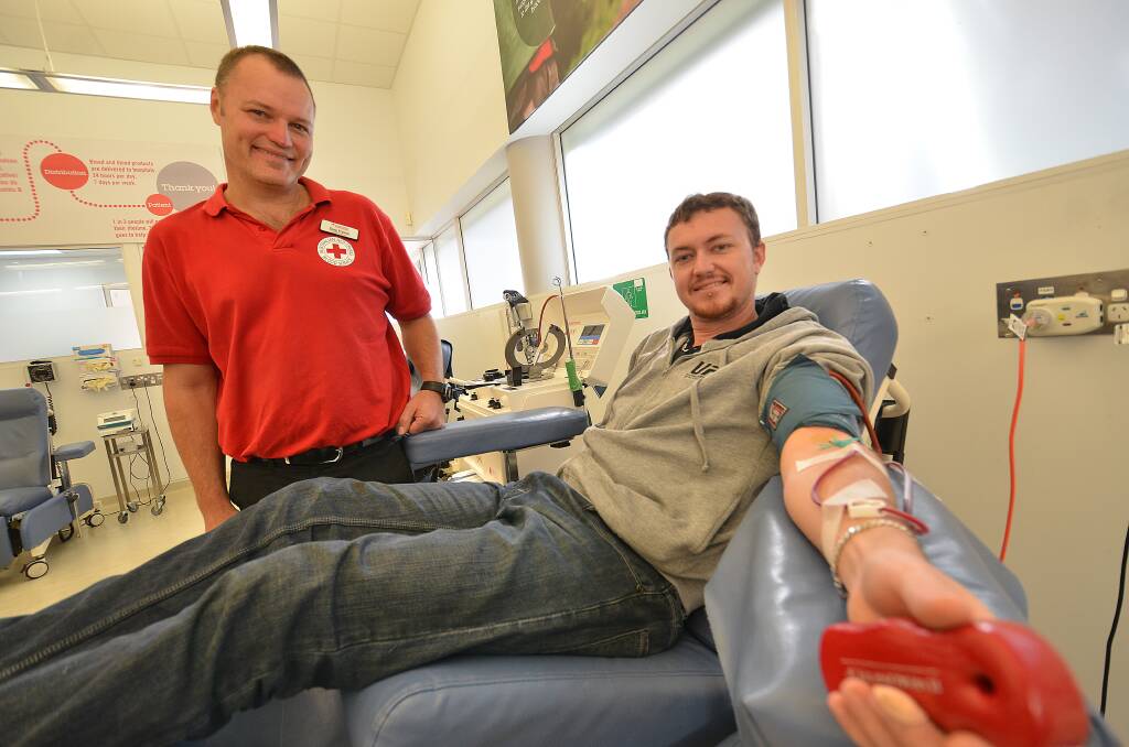 Giving to the cause: Community  
relations Mid-North Coast director with Australian Red Cross, Greg French, with blood donor Daniel Hill.