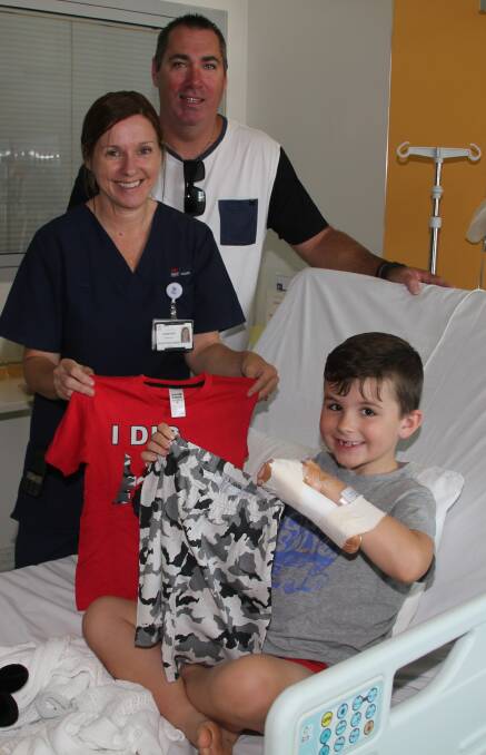 Great gift: Angus Ismay, 7, of King Creek was delighted to receive pyjamas from Jenny Emerson and Justin Cordell, who have launched Callum's Pyjama Army in memory of their son.