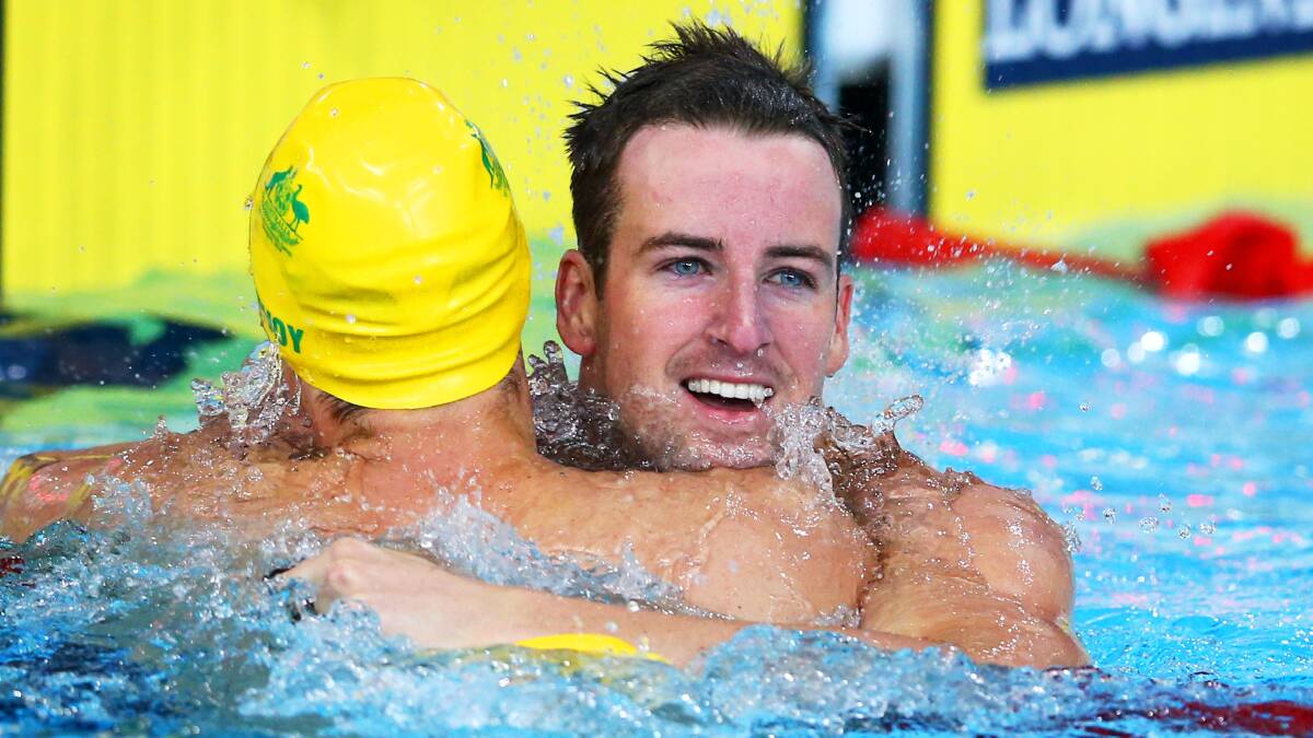 What a team: James Magnussen cradles silver medal winner Cameron McEvoy as the celebrations begin. Pic: GETTY IMAGES