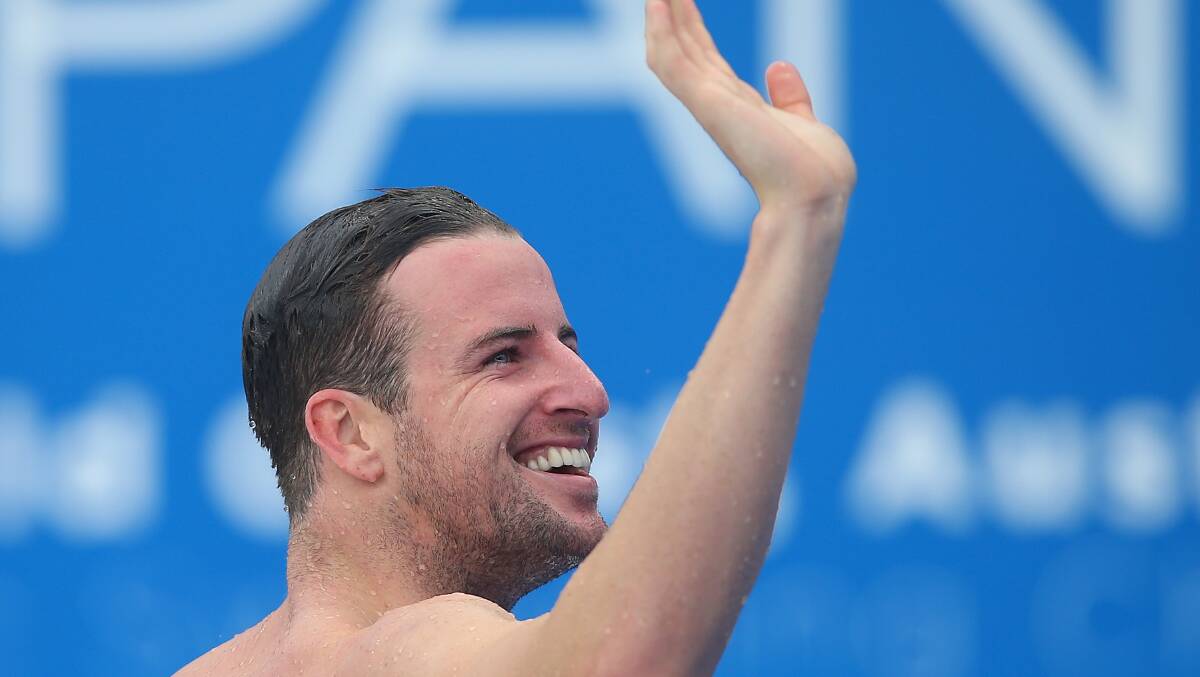 James Magnussen waves to the crowd after Friday night's 100m final in which he claimed bronze.