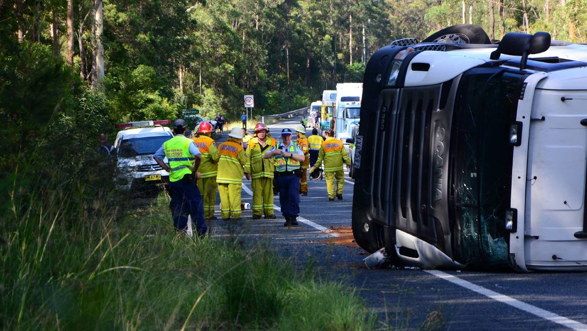 Police and emergency services next to the overturned truck at Kundabung. Pic: TODD CONNAUGHTON