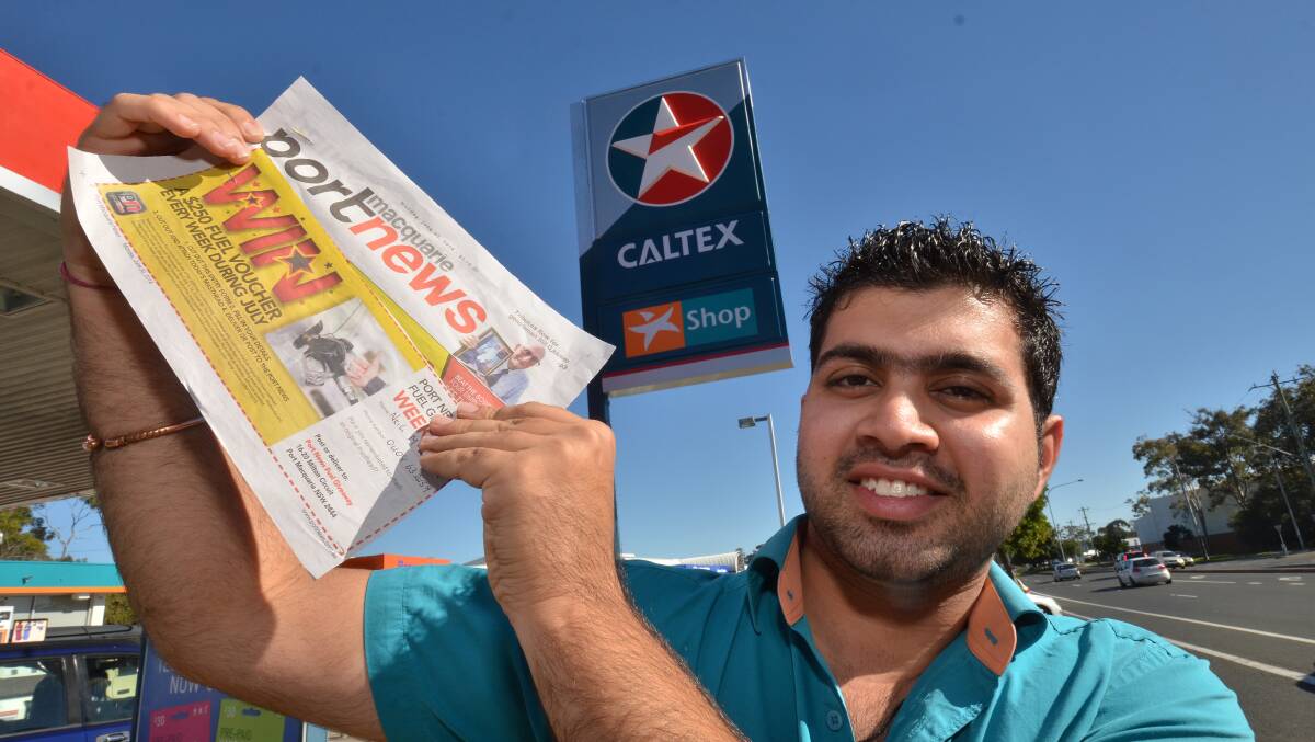 And the winner is: Hastings River Drive Caltex manager Sahil Arga, draws the winning voucher.