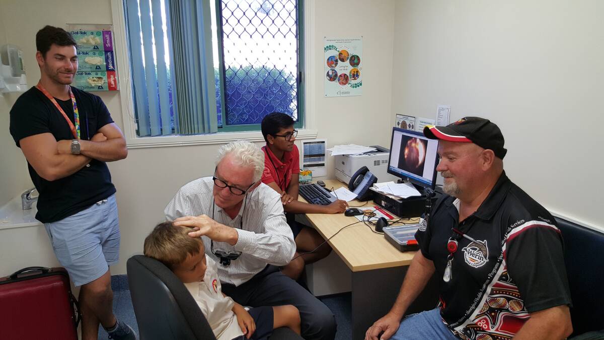 Outreach surgery: The Children's Hospital at Westmead's Dr John Curotta examining a patient as, right,  Laurie Clay from Werin Aboriginal Corporation Medical Centre and two medical students from UWS look on.