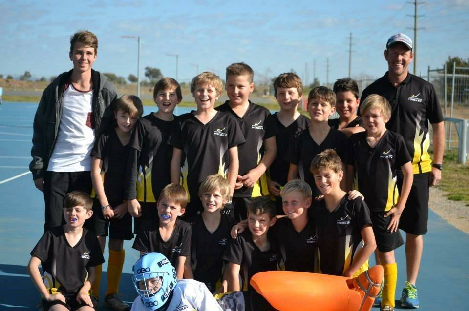 Top dad: Jarrod Smith (right) with the Port Macquarie Hastings Hockey Association's first ever U11s representative team. Jarrod is a nominee in the Philips Community Sports Dad of the Year Awards for his contributions to the development of local hockey.