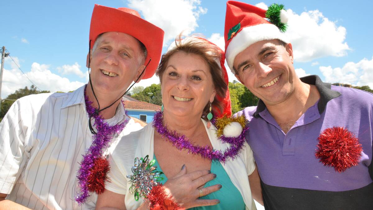 Opening their arms to those in need: Max and Karen Davies with Chris Beazley are calling for volunteers for this year's Christmas on the beach.