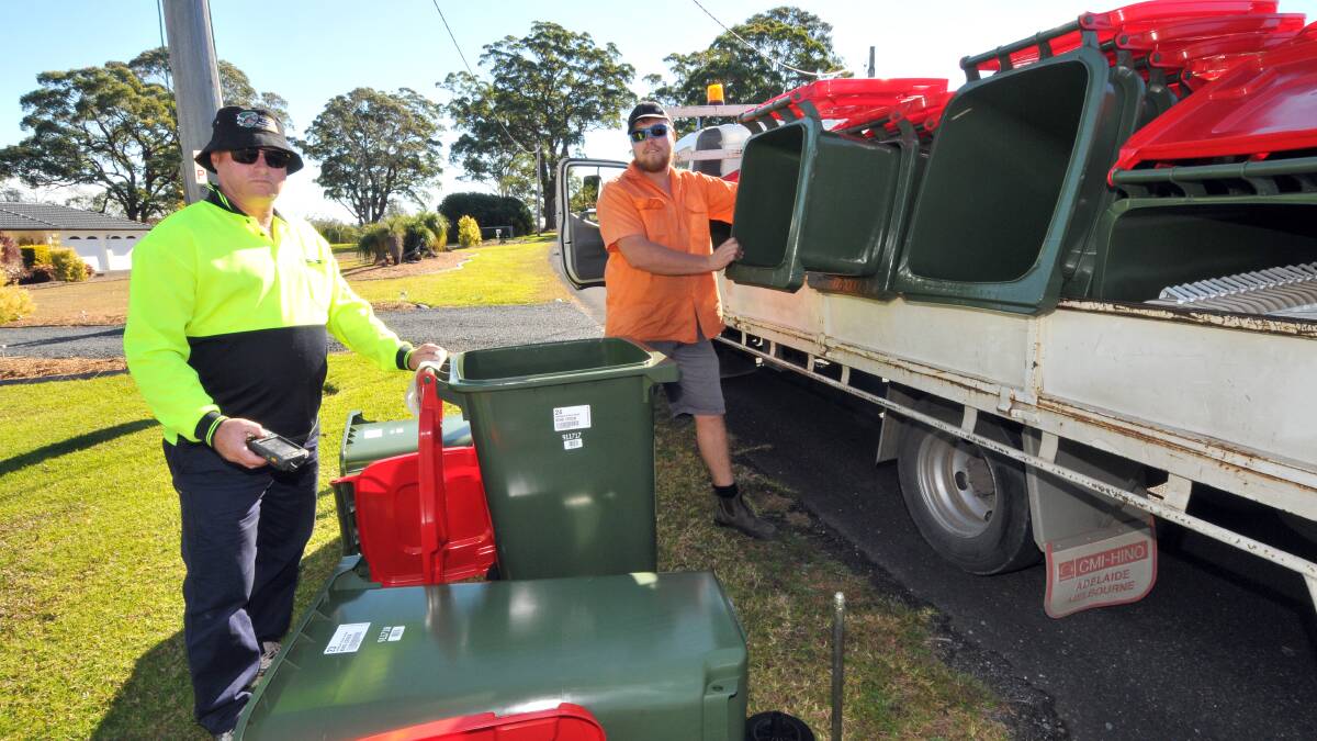 On track: Steve Mackintosh and Alex Scott deliver red bins at King Creek.
