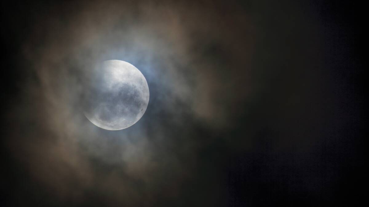 Red moon under a cloudy cover: PHOTOS
