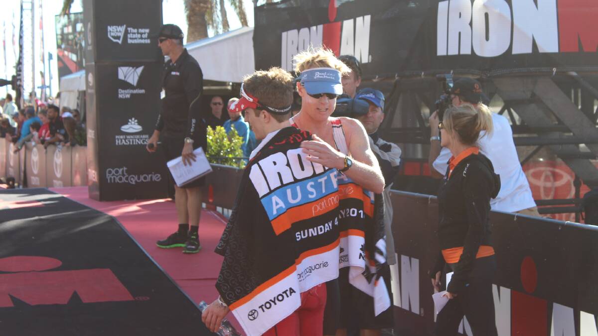 Ironman Australia 2014 winner Elliot Holtham and runner-up Paul Ambrose exchange congrats at the finih line.