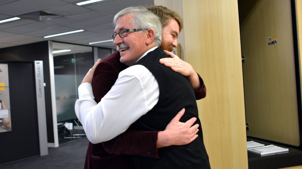 Colin Walker gives reporter Ben Cooper a hug to get him through another day.
