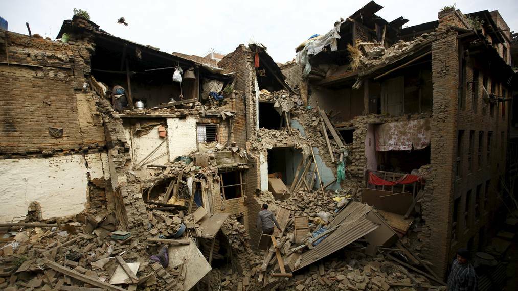 People search for family members trapped inside collapsed houses a day after an earthquake in Bhaktapur, Nepal. Picture: Reuters