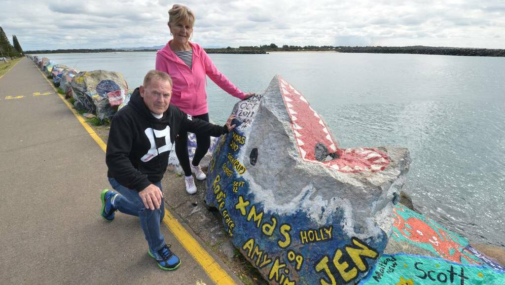 Part of the landscape: Kay and Denny Thompson admire the rock art on the breakwall.