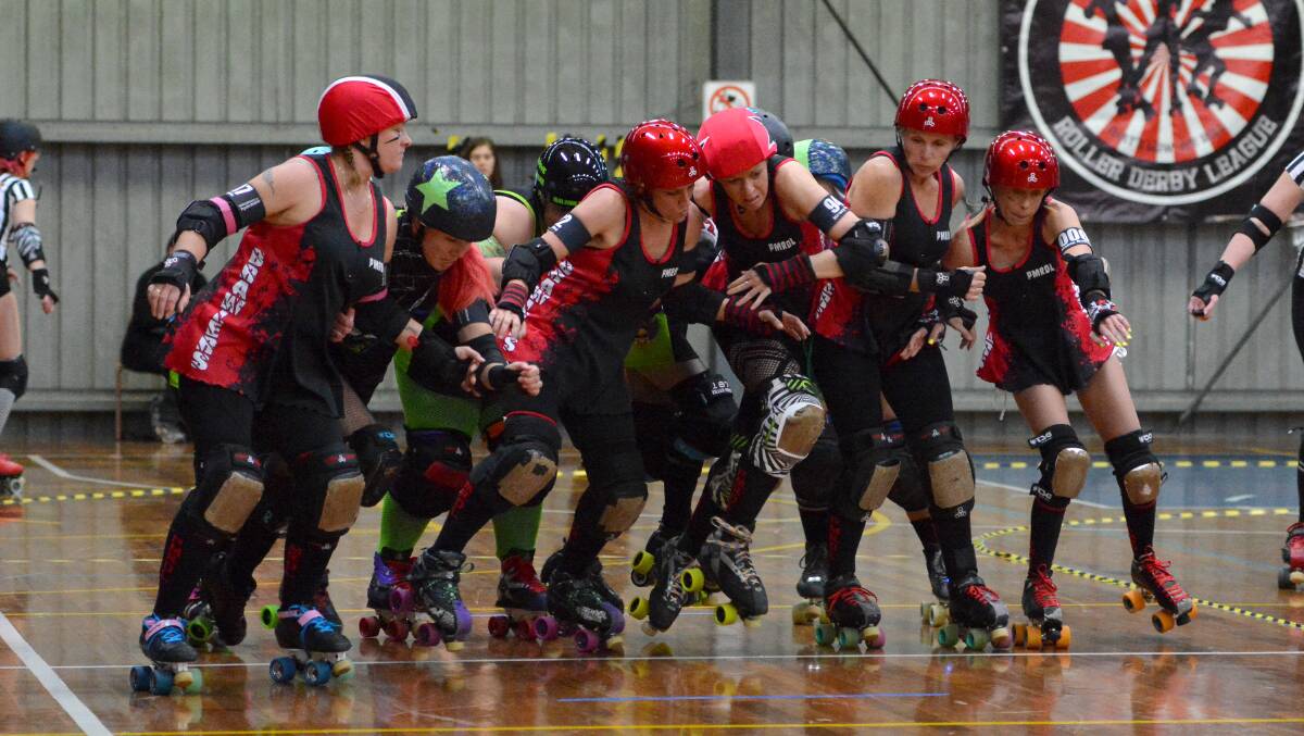 Push and shove: There was a bit of niggle at the start line of the roller derby between the Port Macquarie Breakwall Brawlers and the Central Coast Knockout Saffires.