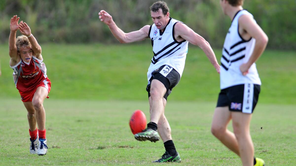 Jason Smith kicks forward for Port Magpies in the loss to Coffs Swans