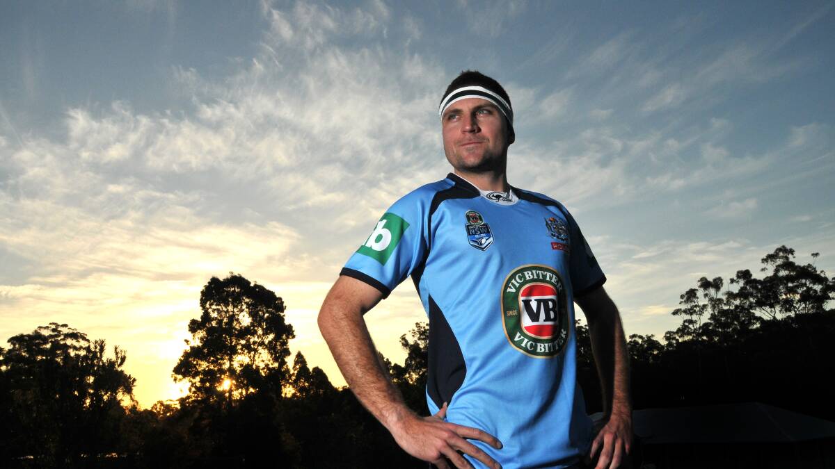 Spitting image: Mark Harris offers his support to the NSW Blues and takes on the persona of hooker Robbie Farah.