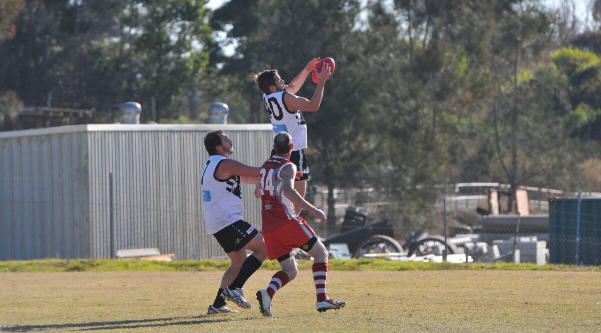 Flying high: Magpies' Adam Eckerman takes a mark.
