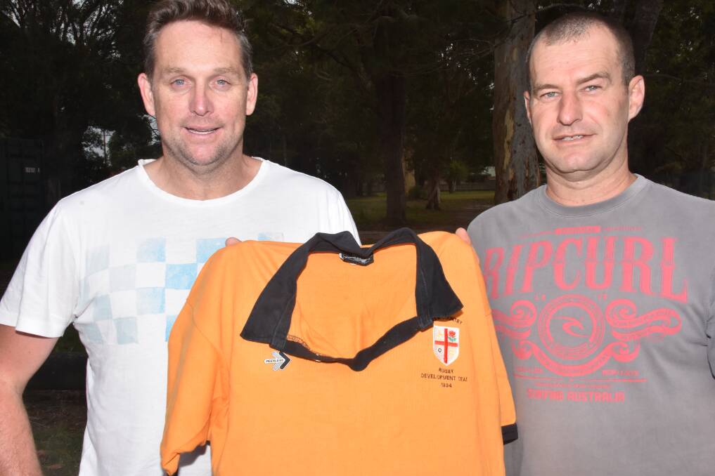 Great memory: Two Port Macquarie residents Damian Lewis and Michael Huxley played against Lomu in the NSW under 21s side. They are holding the jersey from the game.