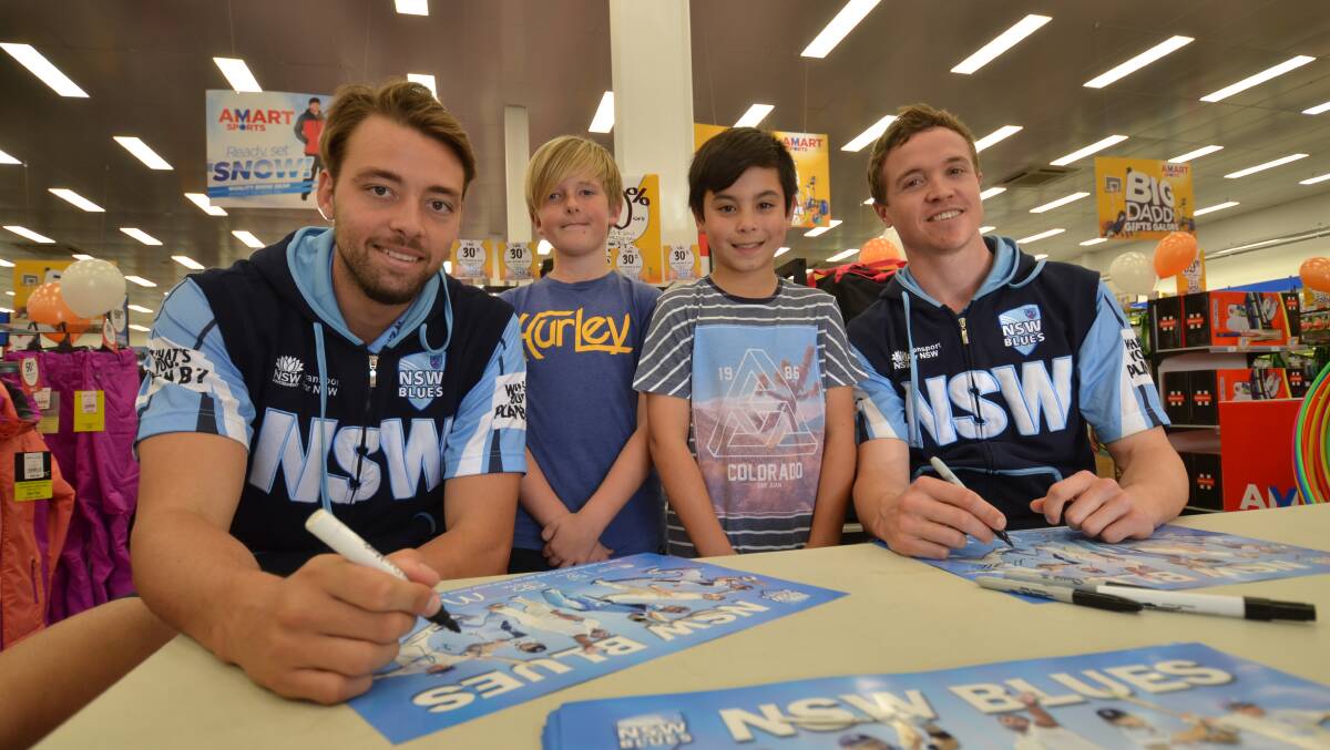 Signing autographs: NSW blues cricketers Harry Conway and Nick Larkin with cricket fans Jake Berne and Adam Dare at Amart Sports on Wednesday.