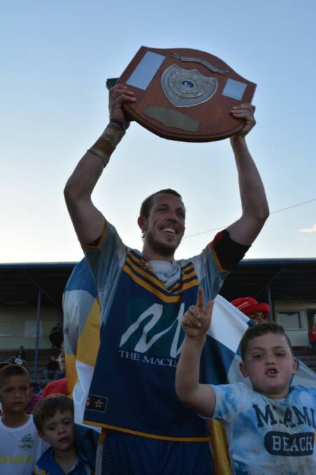 Sam Howe raises the Group 3 shield after winning the grand final. The Macleay Valley Mustangs are hopeful of joining Group 3 again next season. 