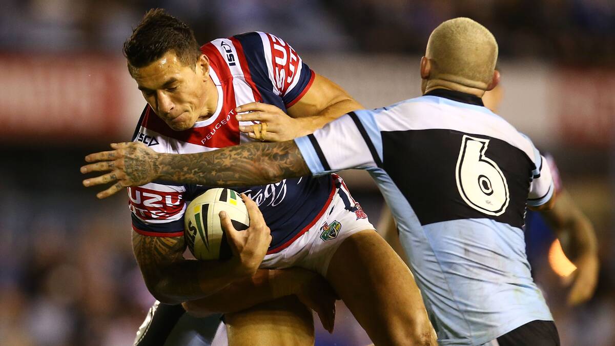 Sonny Bill Williams of the Roosters is tackled by Todd Carney of the Sharks during the round seven NRL match between the Cronulla-Sutherland Sharks and the Sydney Roosters at Remondis Stadium on April 19, 2014 in Sydney, Australia. Photo: Mark Nolan/Getty Images.
