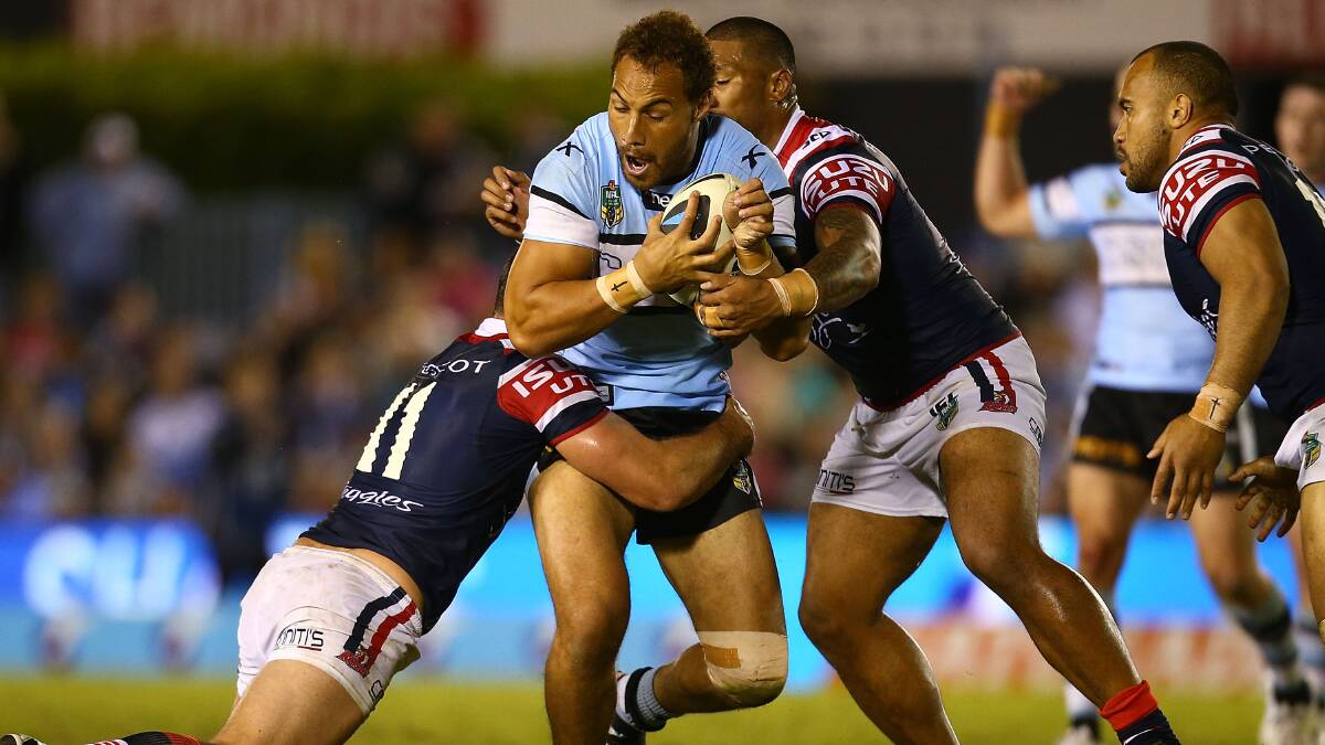 Sam Tagataese of the Sharks is tackled during the round seven NRL match between the Cronulla-Sutherland Sharks and the Sydney Roosters at Remondis Stadium on April 19, 2014 in Sydney, Australia. Photo: Mark Nolan/Getty Images.