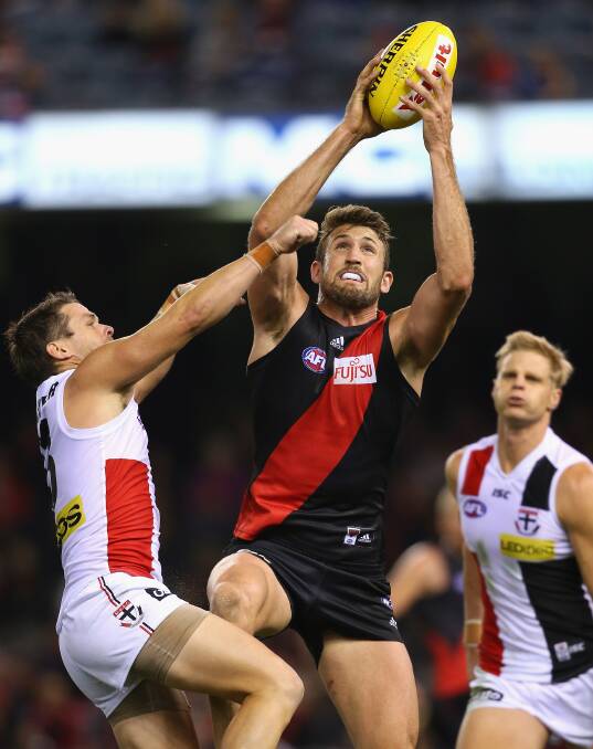 Cale Hooker of the Bombers marks infront of Adam Schneider of the Saints during the round five AFL match between the Essendon Bombers and the St Kilda Saints at Etihad Stadium on April 19, 2014 in Melbourne, Australia. Photo: Quinn Rooney/Getty Images.