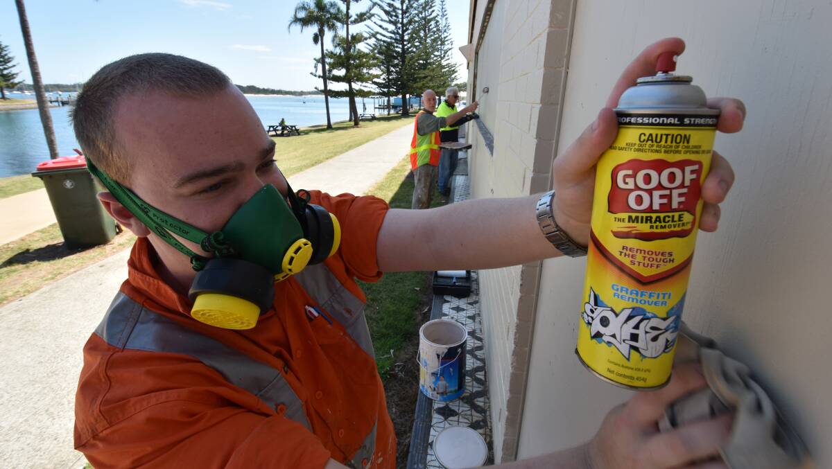 Clean up: Port Macquarie-Hastings Council Graffiti Blasters volunteers Joshua Pring, John McDonald and Stuart Chapman remove stubborn spots and paint over tags on the Food for Less building on Williams Street.