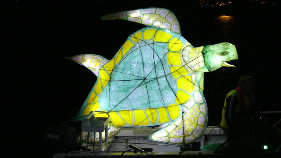 A ghostly turtle lantern glides by