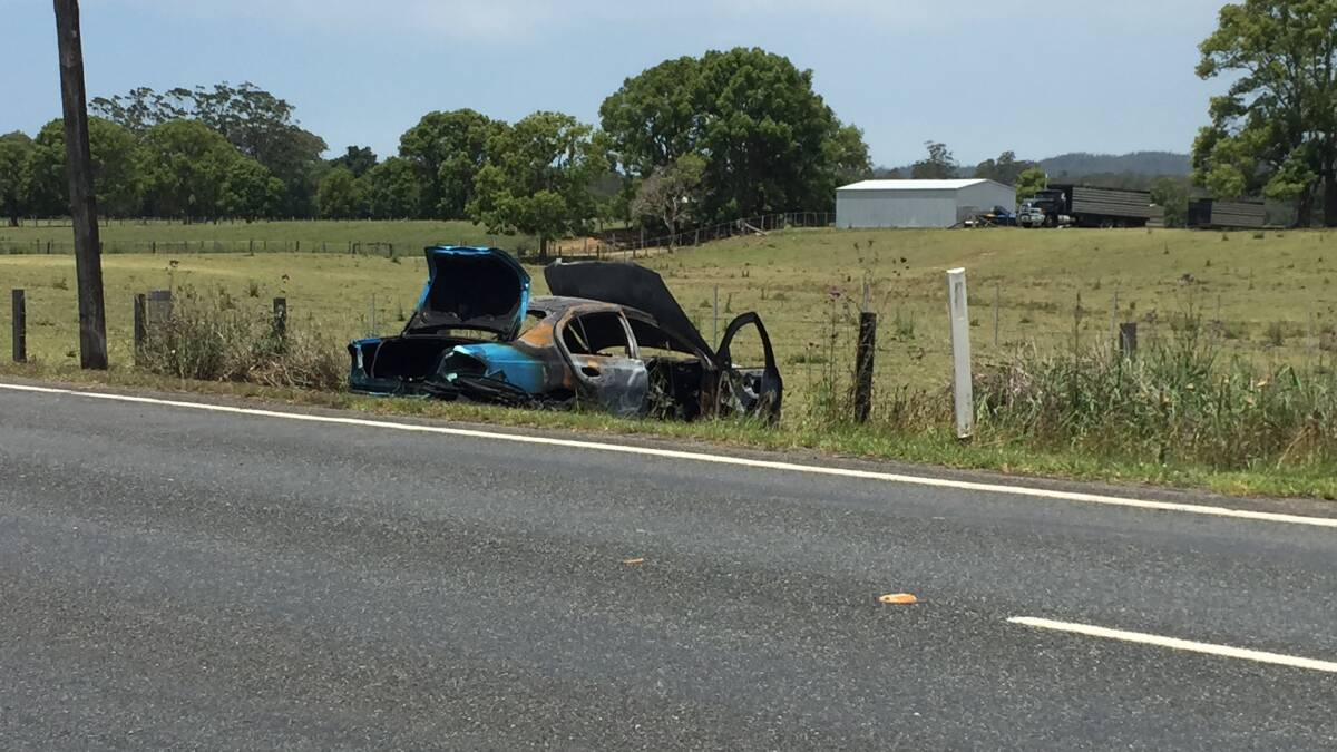 The burned wreck of the vehicle at the accident on the Oxley Highway east of Wauchope.