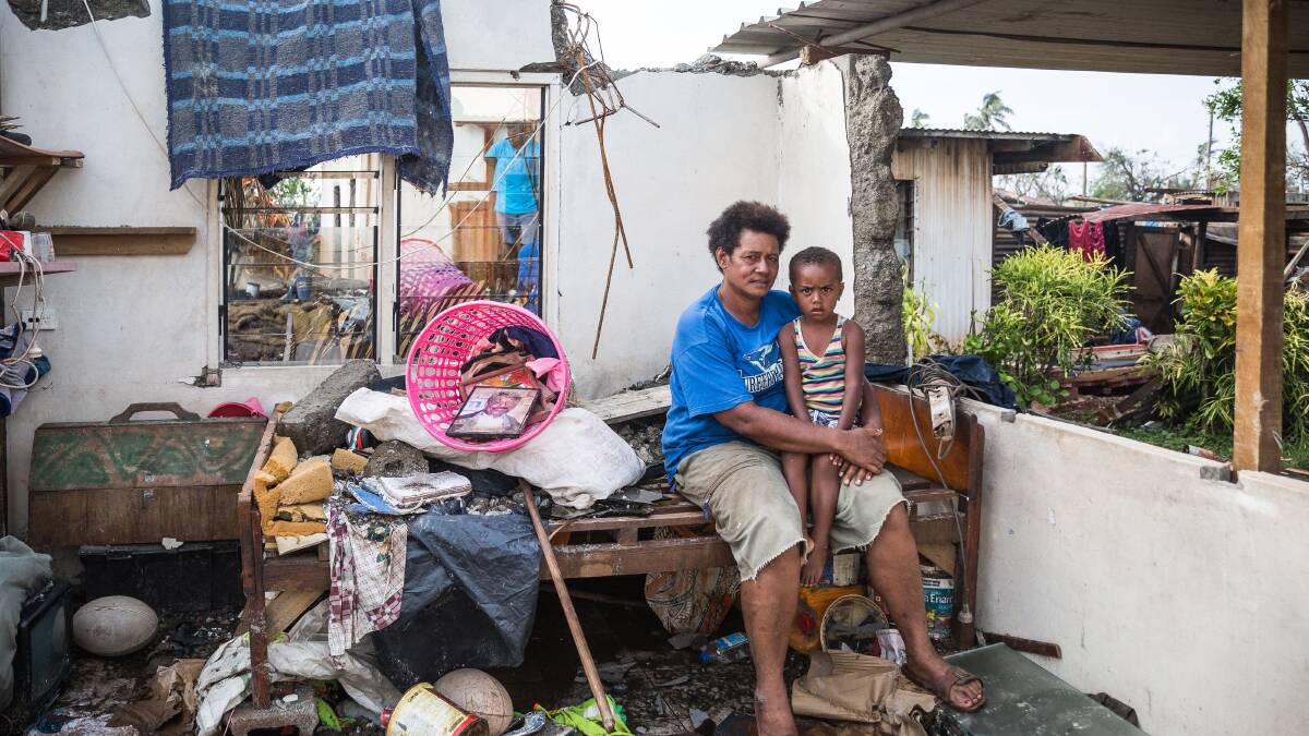 In this handout image supplied by the UNICEF, Kalisi holds her son Tuvosa, 3, in the remnants of her house in Rakiraki District in Ra province on February 24, 2016 in Fiji. Category 5 Tropical Cyclone Winston made landfall in Fiji on Saturday 20 February, continuing its path of destruction into Sunday 21 February. A state of natural disaster and a nationwide curfew had been declared by the Government of Fiji earlier in the evening. The Fijian Government has declared a state of natural disaster for the next 30 days and has initiated the clean-up process by clearing the huge amounts of debris scattered everywhere. (Photo by UNICEF via Getty Images)