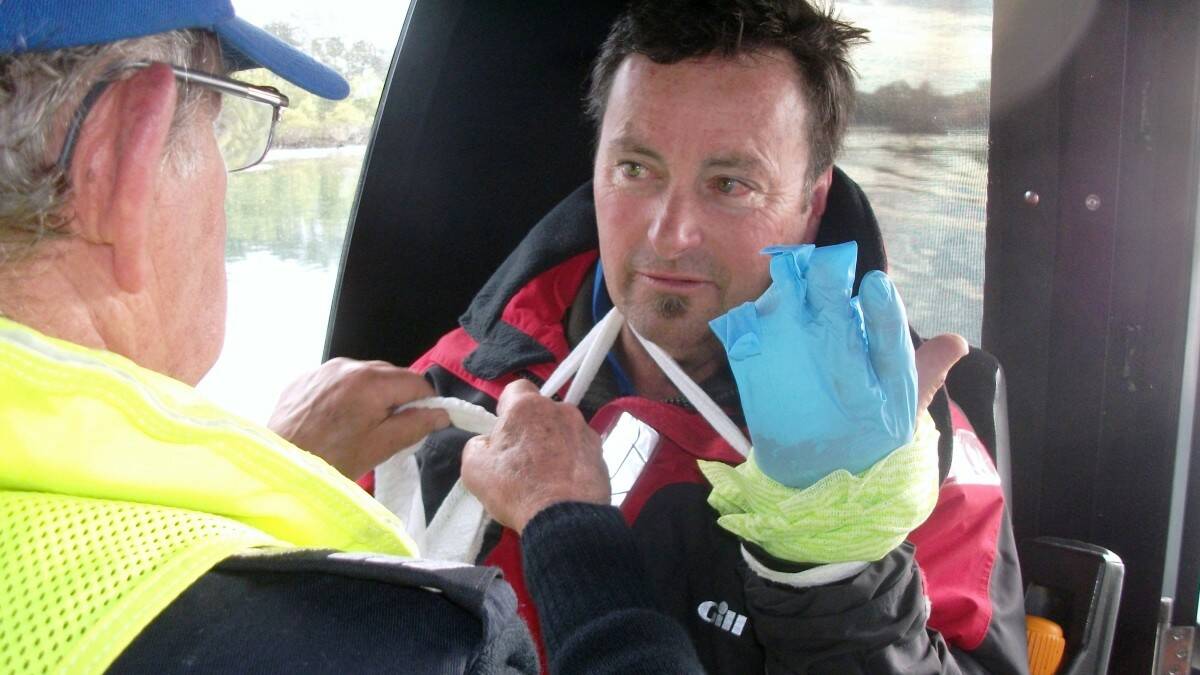 Phillip Wold is given first aid by a member of the Camden Haven Marine Rescue enroute to Laurieton.