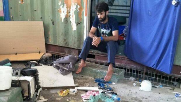 A man inside the decommissioned detention centre, where belongings were reportedly trashed in a police operation on Thursday. Photo: Supplied