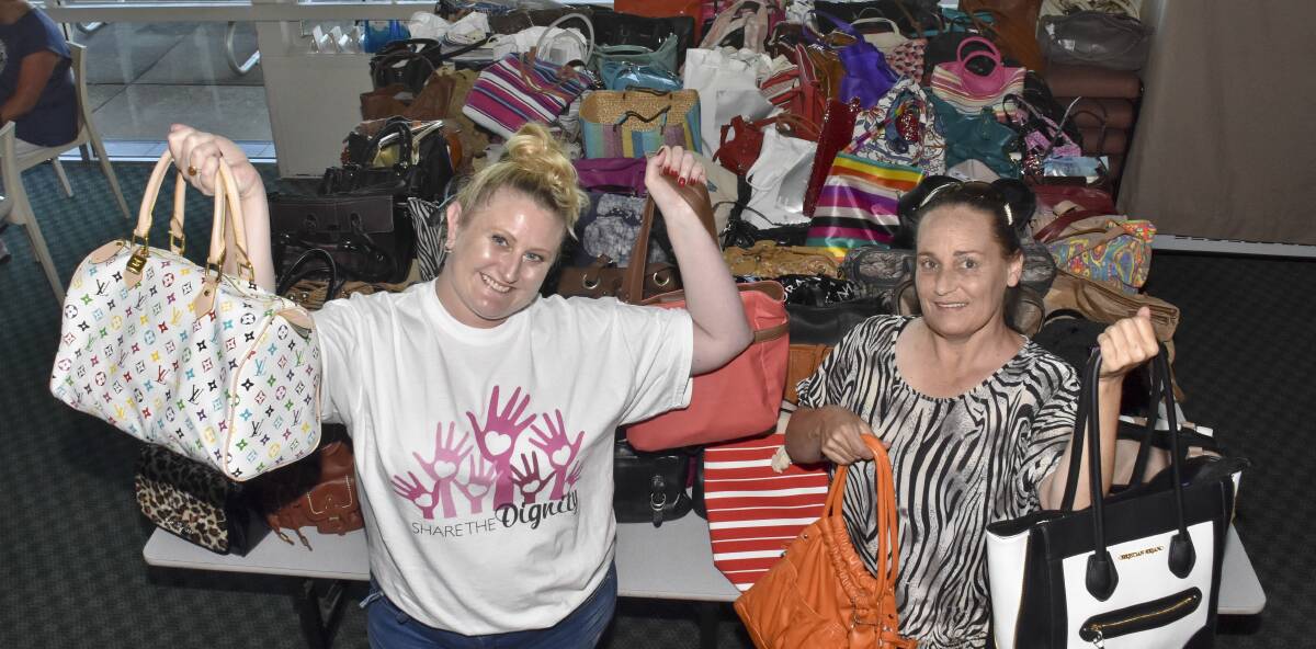 HANDBAG BOUNTY: Amber Reeve and Michelle Teerman with the bags brimming with goodies to give women doing it tough a Christmas boost.