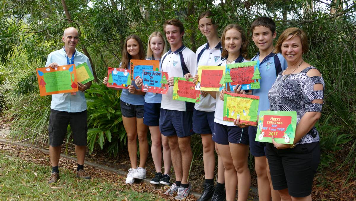 HEARTFELT COMMUNICATION: Some of the students heading to Borneo with teachers James Rourke and Sally Baker, holding cards they received from the partnership school.