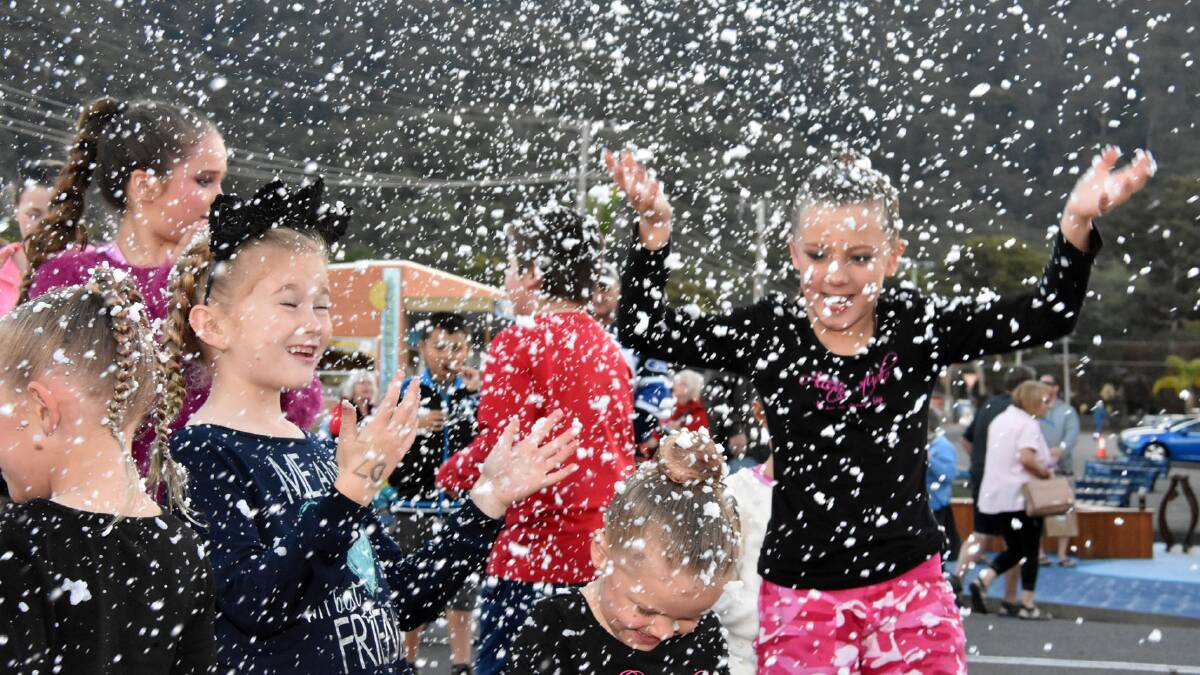 SNOW IN LAURIETON: Between performances, young dancers could be found enjoying the snow machines at Christmas in July on Saturday.