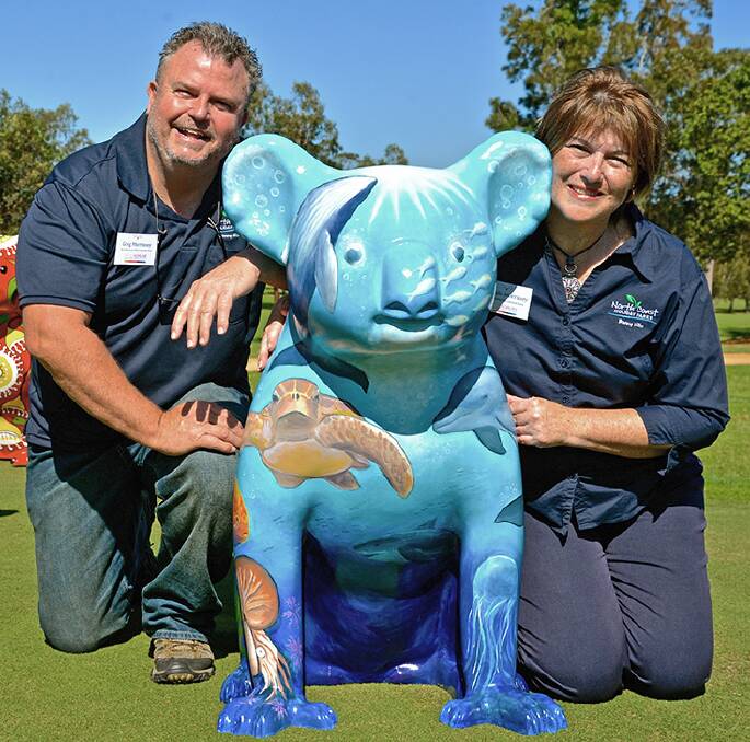 Greg and Michelle Morrissey, managers of the North Coast Holiday Park Bonny Hills, with the park's popular koala.