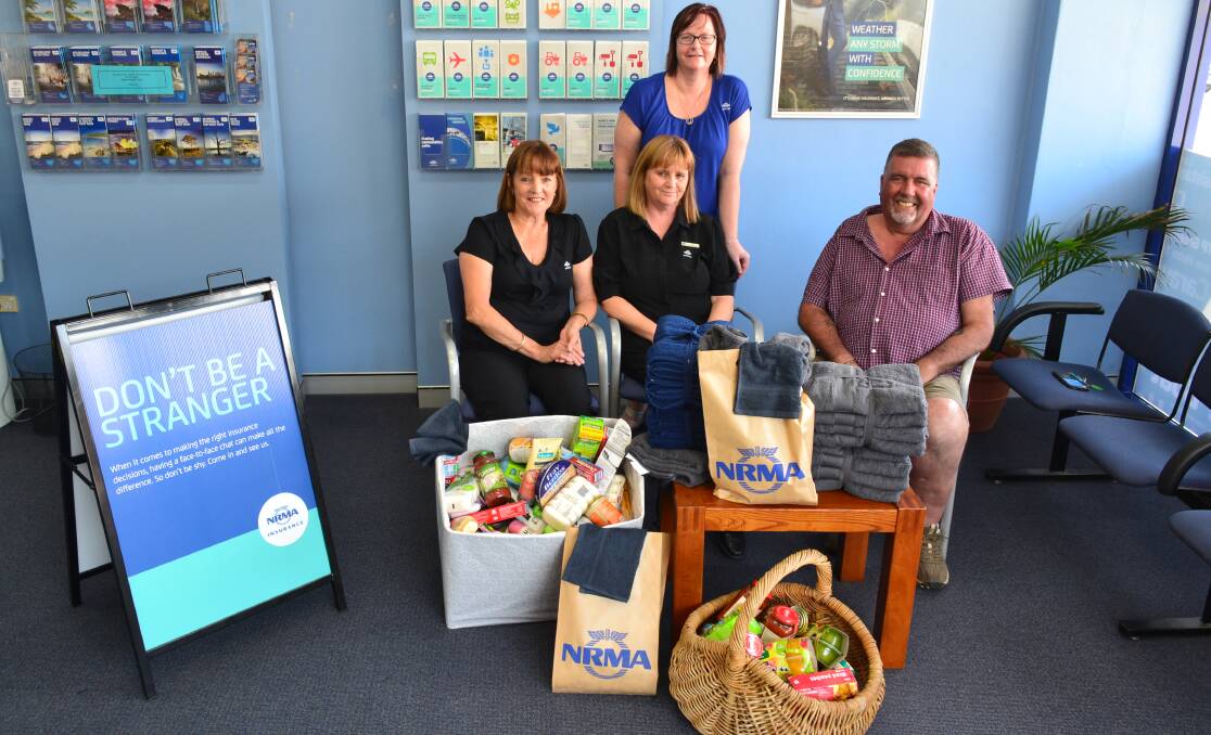 TIME TO GIVE: Laurieton's NRMA team, Lynda Whittingham, Jen Nix and Cindy Gee, with Camden Haven Community at 3 organiser Graham Lee and the donations they have purchased so far.