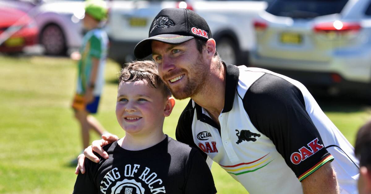 Much delight: Young fan Rhys Jones with Penrith Panthers half James Maloney in Port Macquarie on Thursday. Photo: Matt Attard