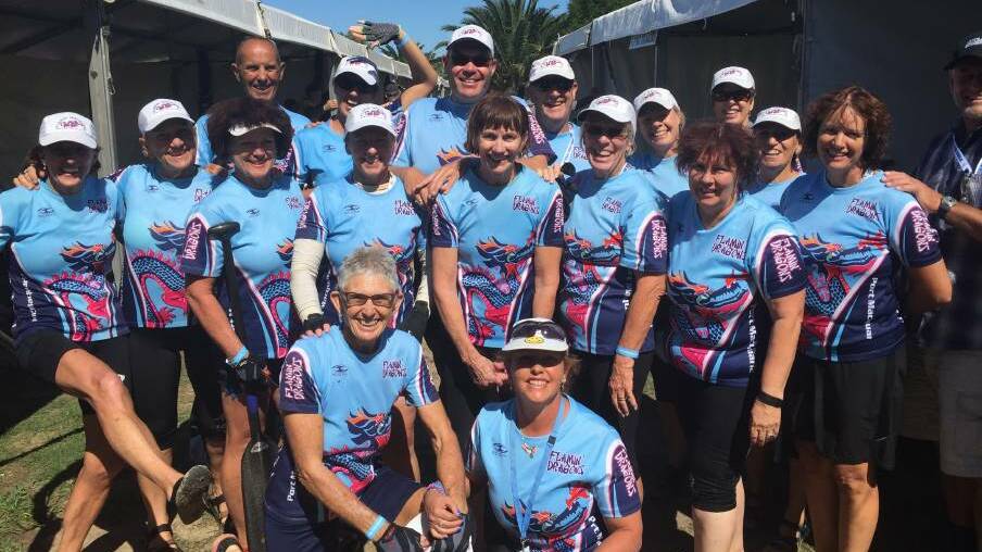 Jenny Higgins, third from the left, with her Port Macquarie dragon boating team, the Flamin Dragons