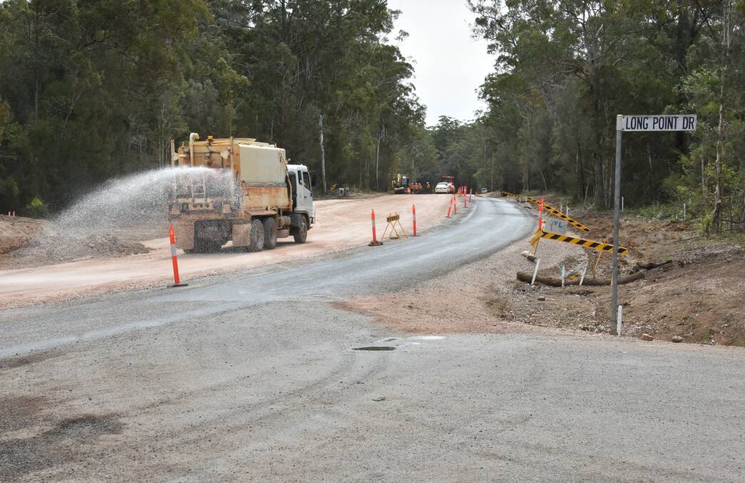 Work continues: A water truck sprays the surface as works on Houston Mitchell Drive continued on Wednesday, October 26. Photo: Ivan Sajko