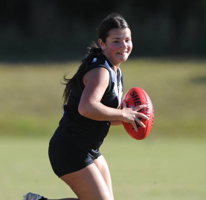 Running the ball: Youth girls Magpies player Shelby Grainger evades the defence in a match last year. The club's registration day is on Sunday at Settlers Inn.