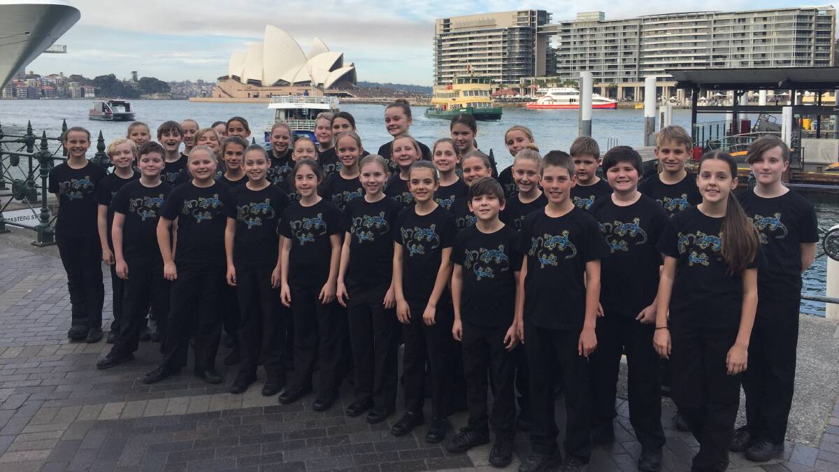 The Tacking Point Bel Canto choir with the famous Sydney Opera House behind them.